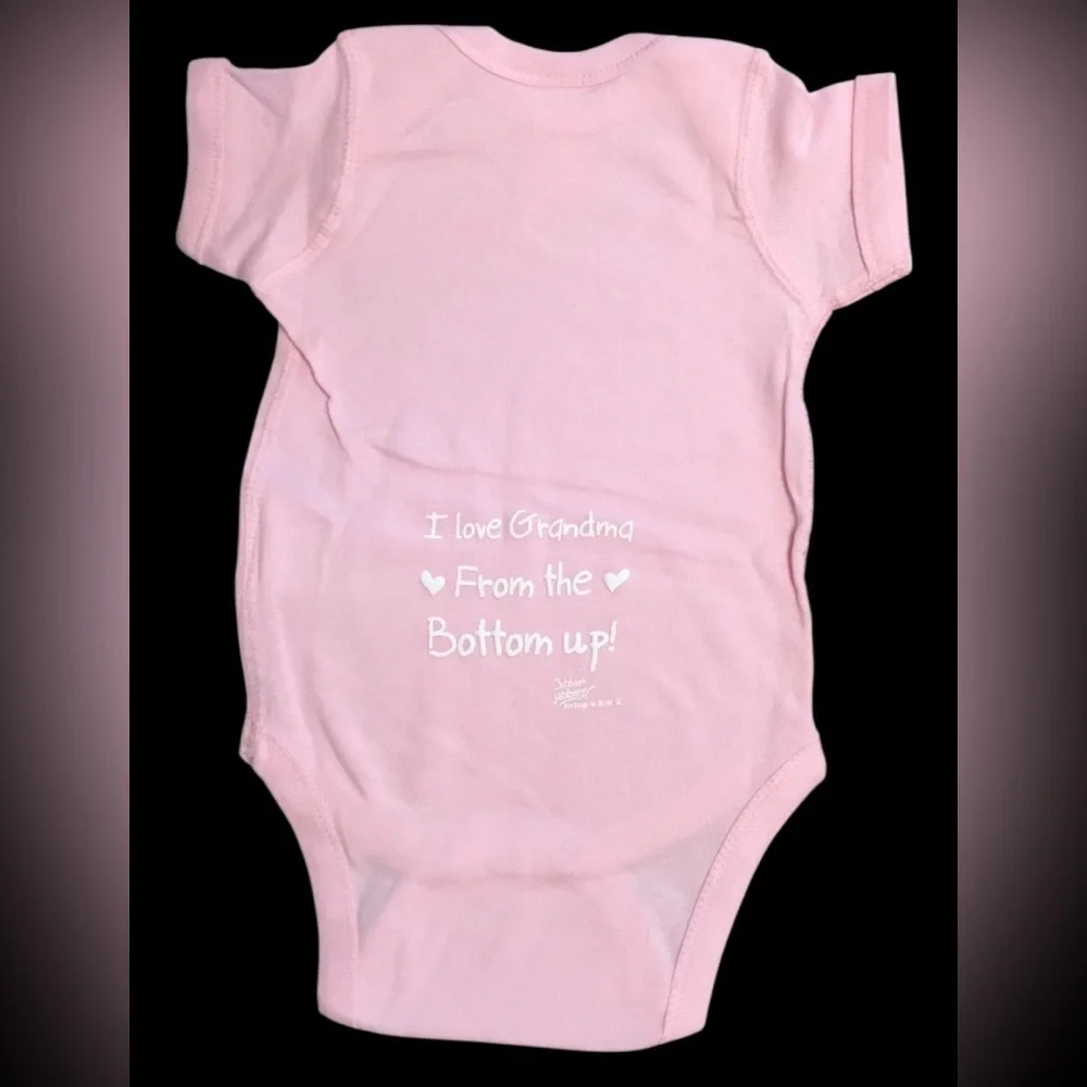 Pink Baby One-Piece Bodysuit w/White Print “I Love Grandma From The Bottom Up!”.